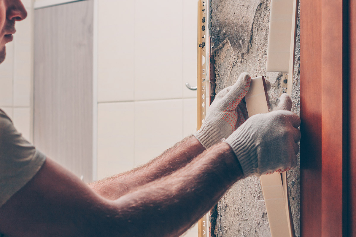 man repairing wall