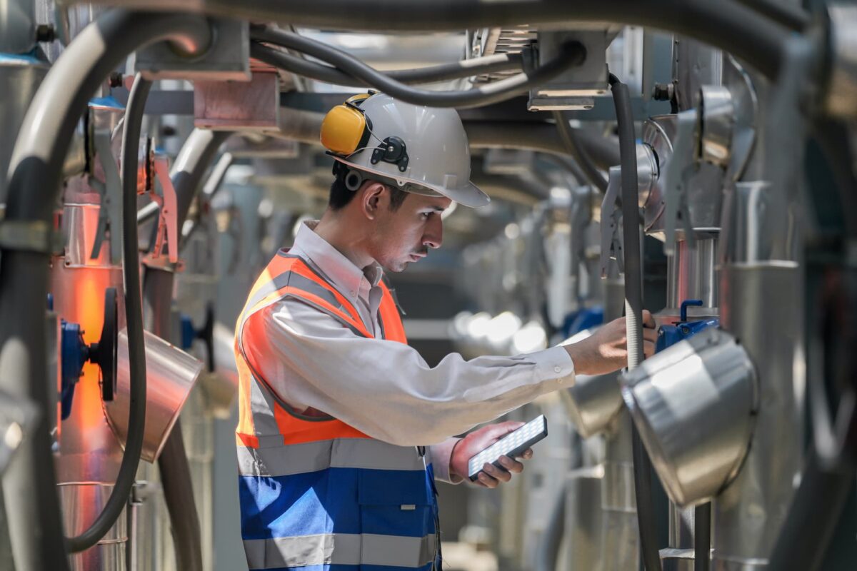 man inspecting industrial equipment
